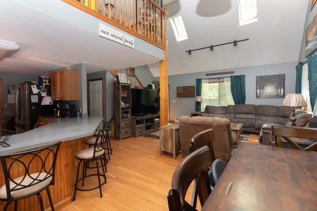 72 Bond Road Charlton, MA 01507 - Photo 3 of 36 a living room with furniture a flat screen tv and kitchen view