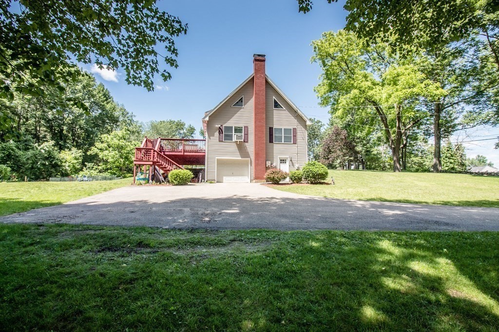 72 Bond Road Charlton, MA 01507 - Photo 32 of 36 a view of green field with small trees in front of it