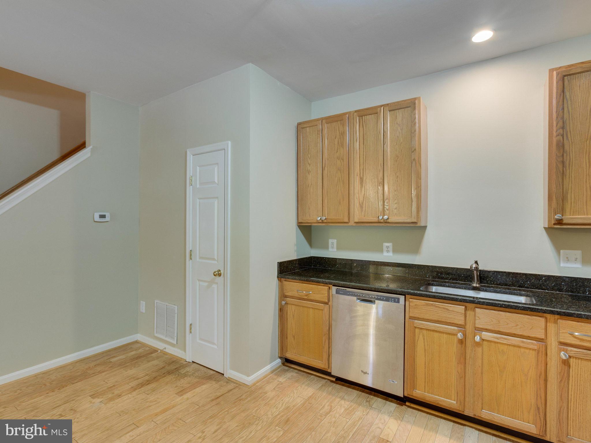 10613 Lockerbie Way Manassas, VA 20109 - Photo 12 of 27 a kitchen with granite countertop white cabinets and sink