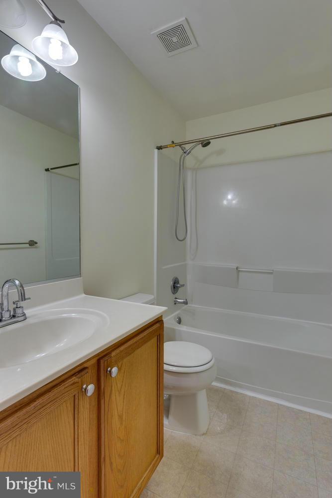 10613 Lockerbie Way Manassas, VA 20109 - Photo 17 of 27 a bathroom with a sink toilet vanity and shower