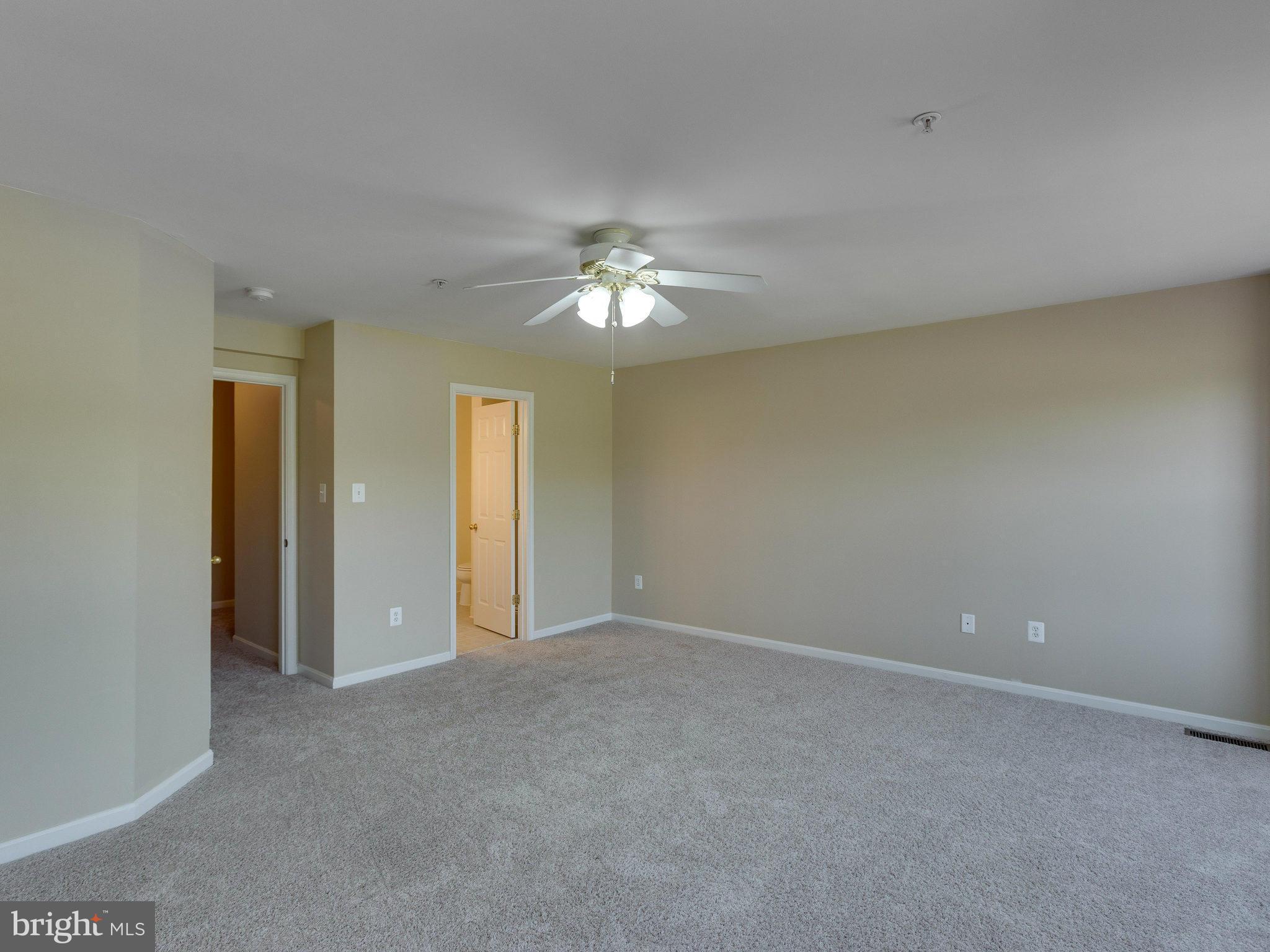 10613 Lockerbie Way Manassas, VA 20109 - Photo 20 of 27 a view of an empty room with a ceiling fan