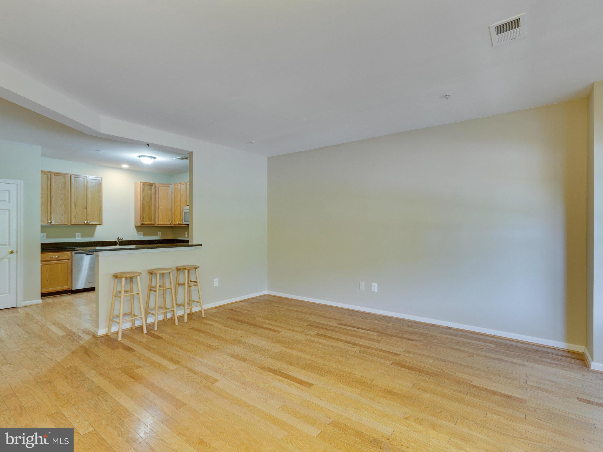 10613 Lockerbie Way Manassas, VA 20109 - Photo 4 of 27 a view of a livingroom with kitchen and furniture