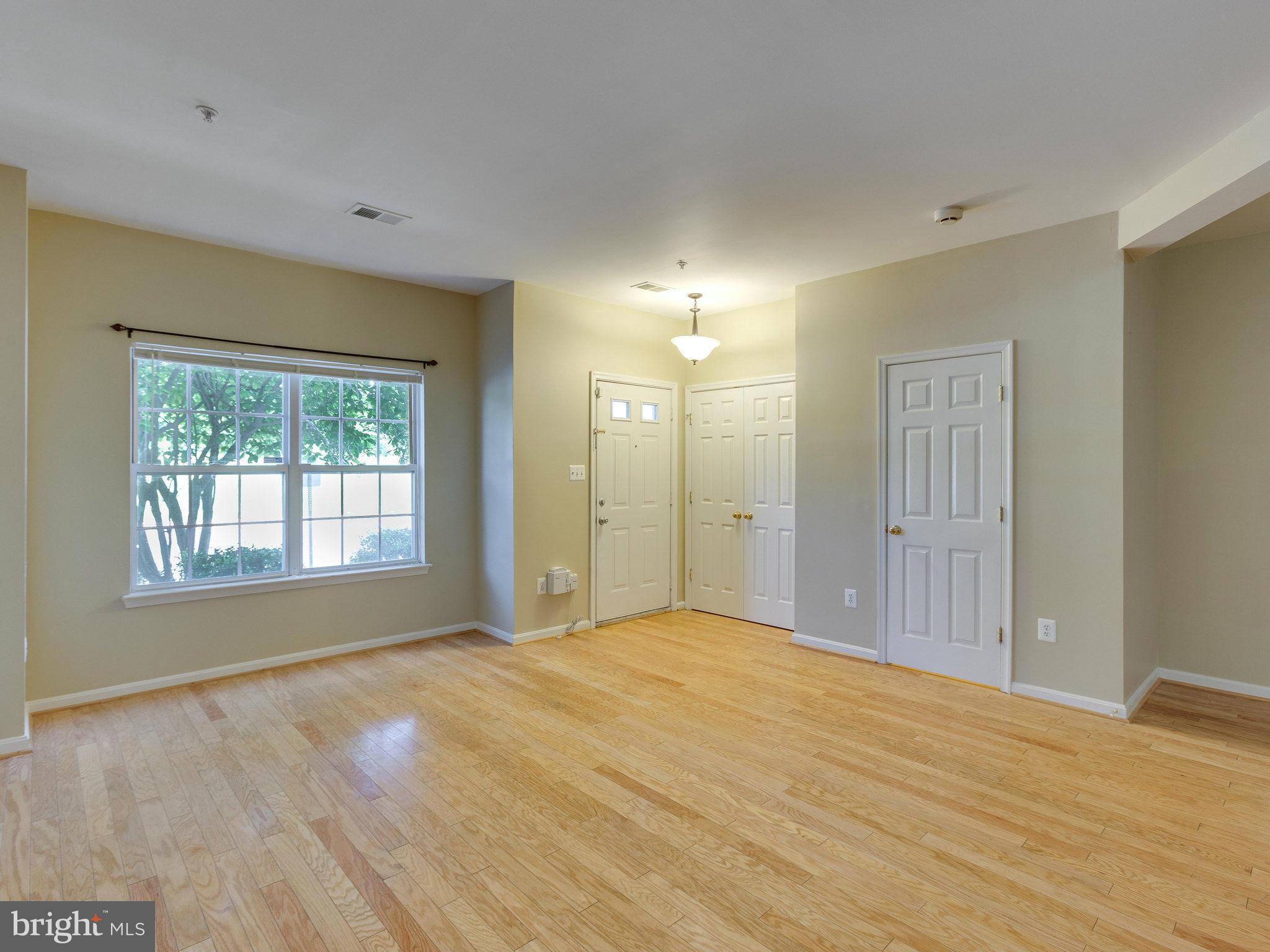10613 Lockerbie Way Manassas, VA 20109 - Photo 6 of 27 a view of an empty room with wooden floor and a window