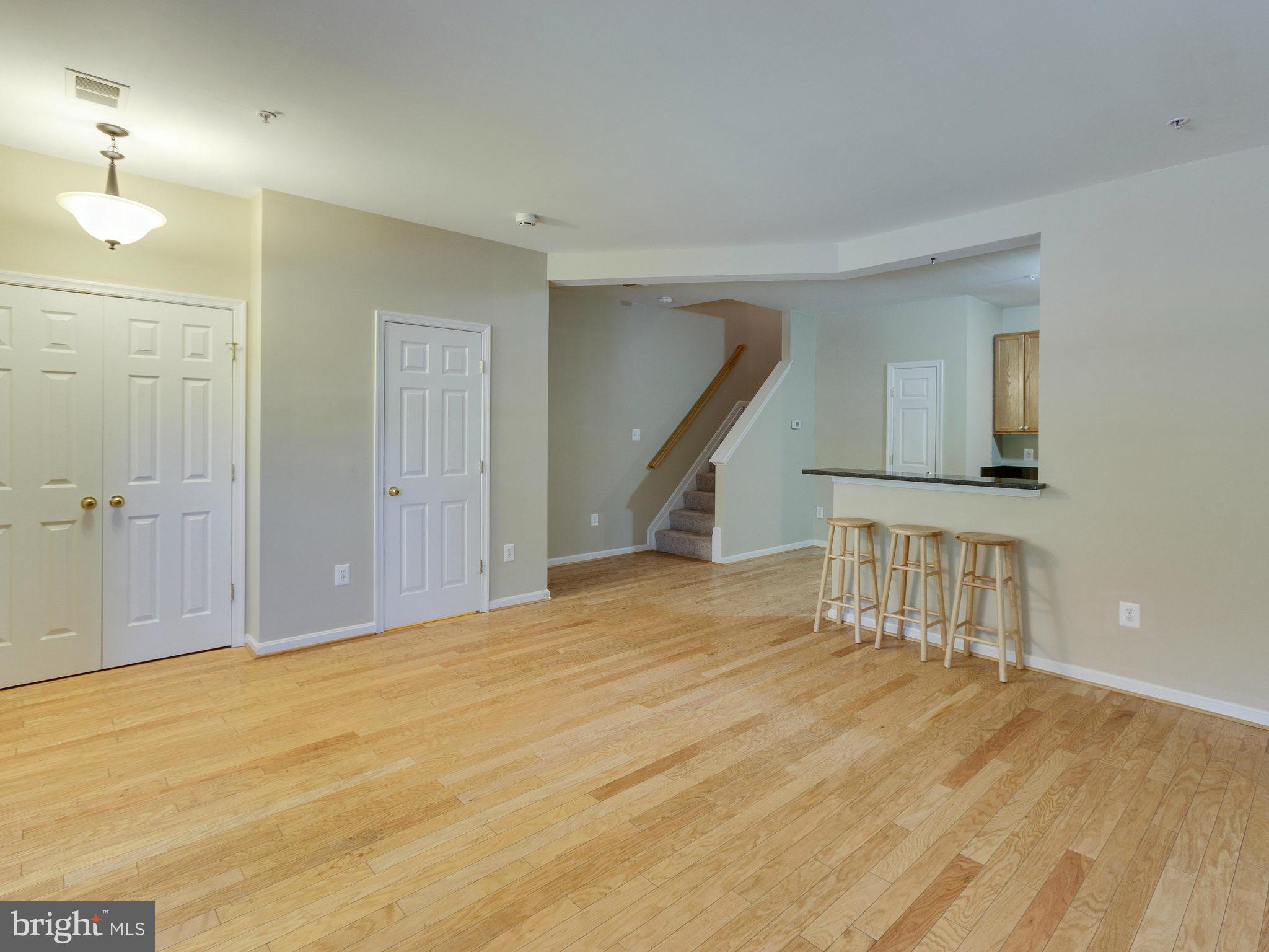 10613 Lockerbie Way Manassas, VA 20109 - Photo 7 of 27 a view of an empty room with wooden floor and a bathroom