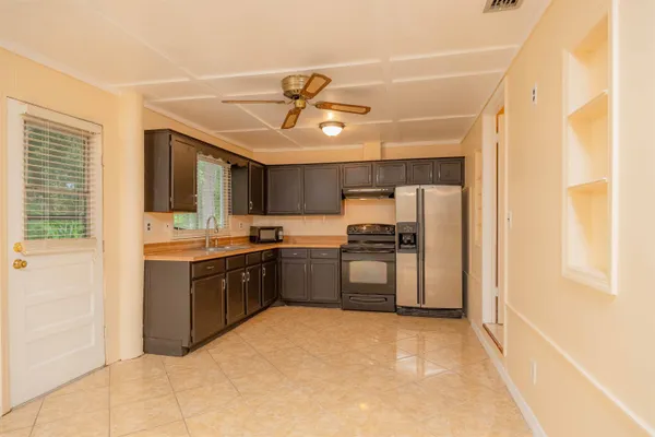 a stove top oven sitting inside of a kitchen
