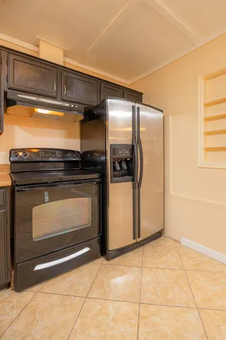 a view of a kitchen with a sink and cabinets