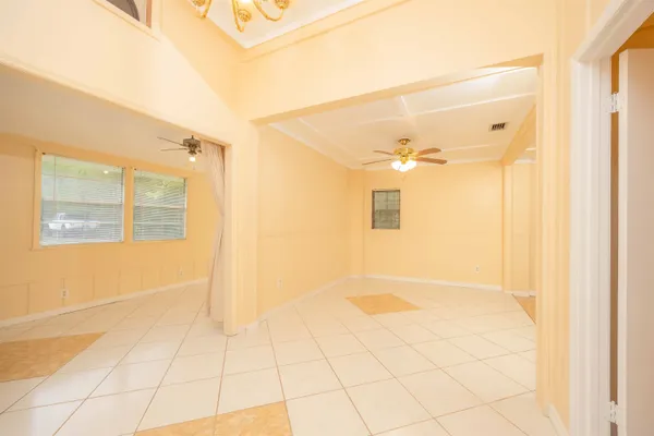 a view of a hallway with a chandelier fan