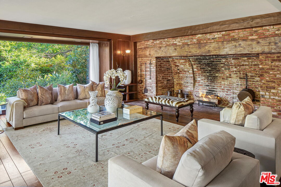 814 Foothill Road Beverly Hills, CA 90210 - Photo 17 of 44 a living room with furniture and a large window