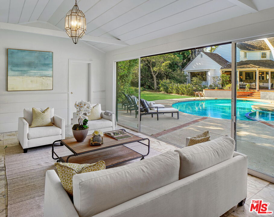 814 Foothill Road Beverly Hills, CA 90210 - Photo 37 of 44 a living room with furniture and a floor to ceiling window