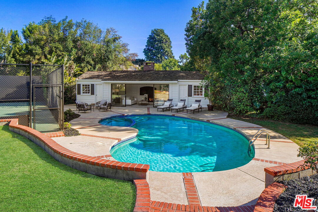 814 Foothill Road Beverly Hills, CA 90210 - Photo 41 of 44 a view of a house with pool fire pit and chairs