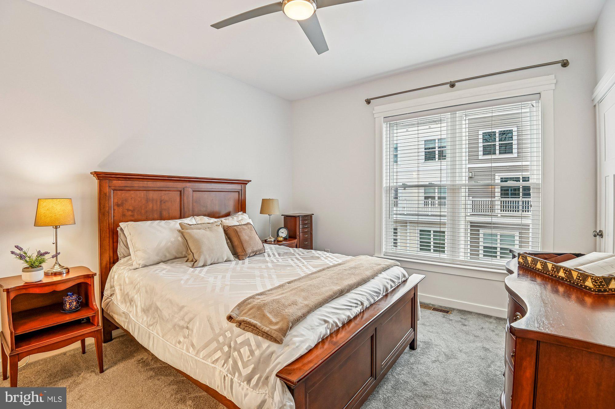 123 Lejeune Way Annapolis, MD 21401 - Photo 21 of 43 a bedroom with a bed and a dresser next to a window