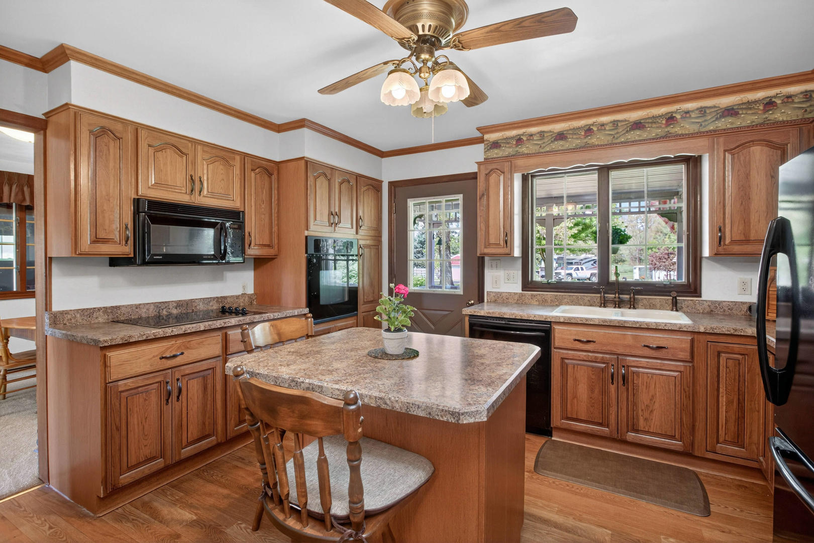 2660 252nd Street De Witt, IA 52742 - Photo 16 of 45 a kitchen with stainless steel appliances granite countertop a stove a sink dishwasher a microwave oven with granite countertops and cabinets