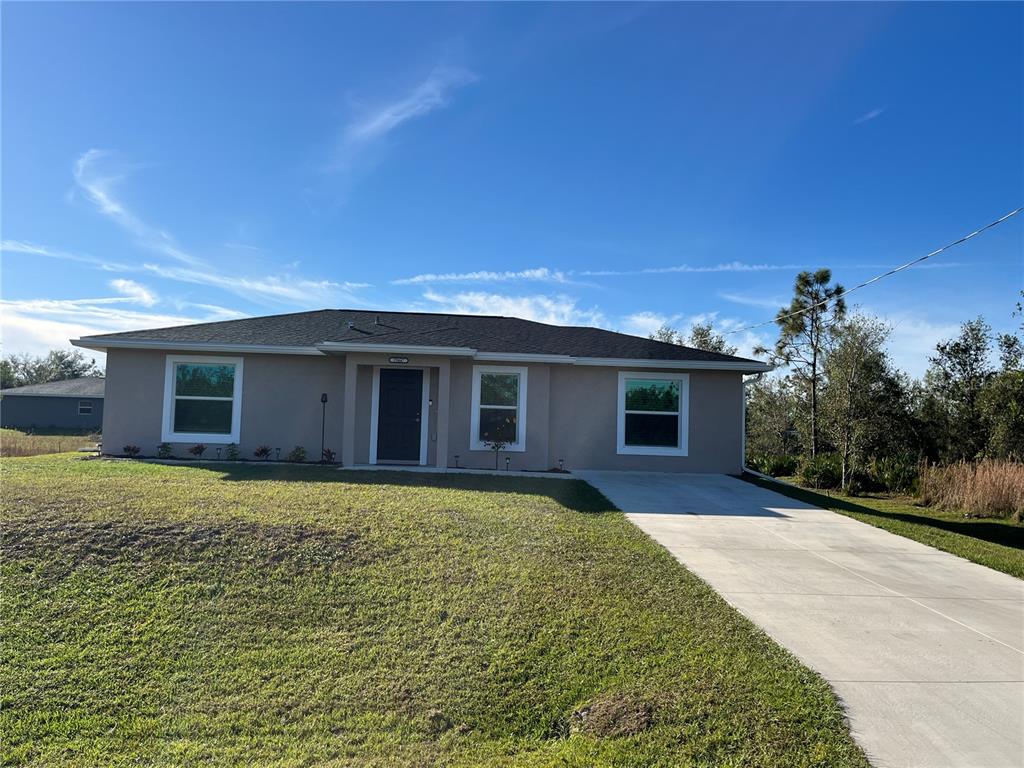 29447 Ixora Road Punta Gorda, FL 33982 - Photo 1 of 1 a front view of a house with garden