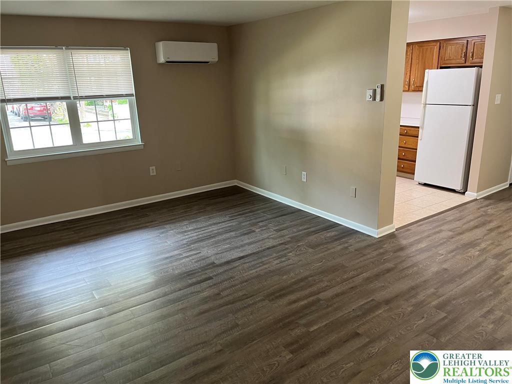 511 Prospect Avenue, Unit 2 Bethlehem, PA 18018 - Photo 2 of 9 an empty room with wooden floor and windows