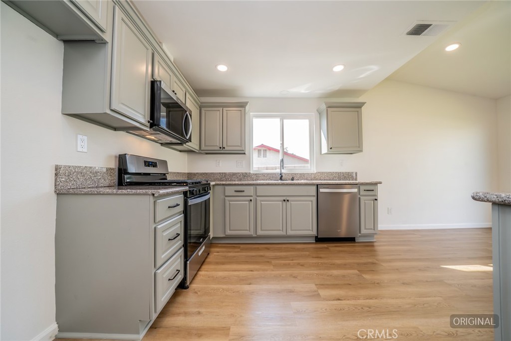 818 Terrace Road San Bernardino, CA 92410 - Photo 14 of 44 a kitchen with stainless steel appliances granite countertop a sink and cabinets