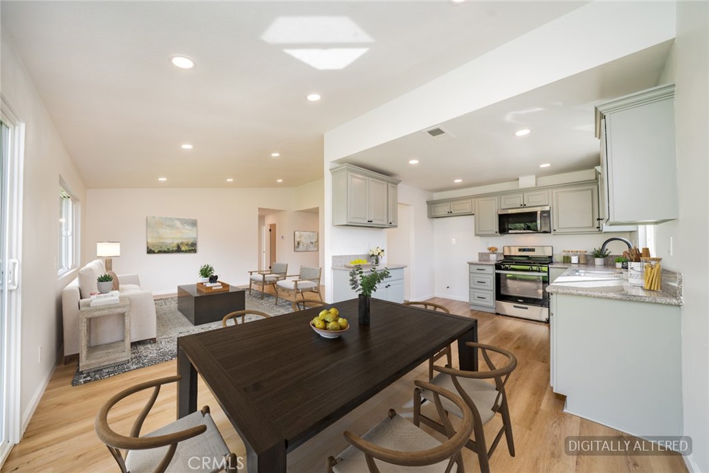 818 Terrace Road San Bernardino, CA 92410 - Photo 15 of 44 a kitchen with a dining table chairs and refrigerator