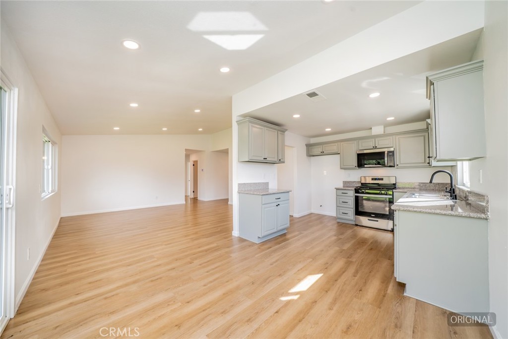 818 Terrace Road San Bernardino, CA 92410 - Photo 16 of 44 a kitchen with stainless steel appliances granite countertop a sink and cabinets