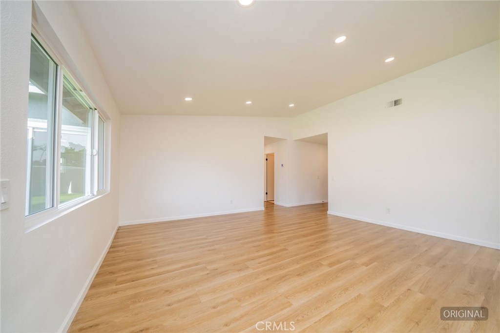 818 Terrace Road San Bernardino, CA 92410 - Photo 18 of 44 a view of an empty room with wooden floor and a window