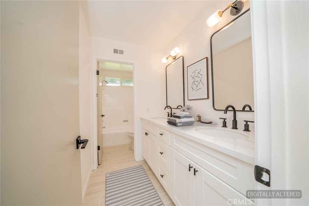 818 Terrace Road San Bernardino, CA 92410 - Photo 19 of 44 a bathroom with double vanity sink and a mirror