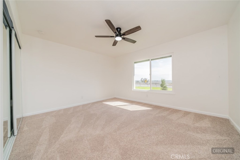 818 Terrace Road San Bernardino, CA 92410 - Photo 22 of 44 an empty room with windows and fan