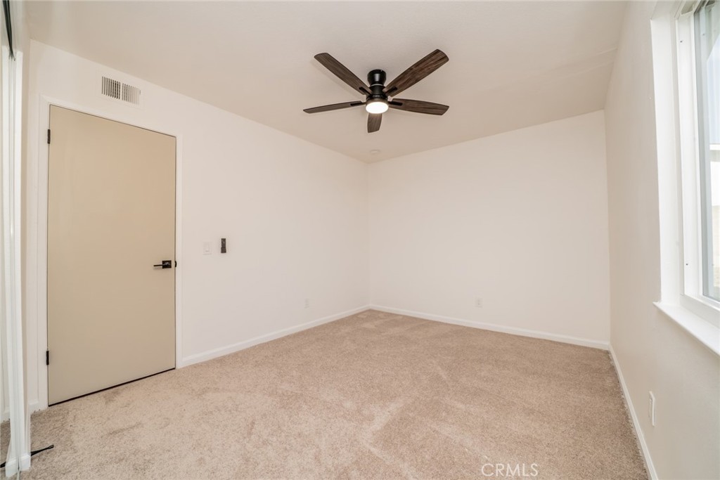 818 Terrace Road San Bernardino, CA 92410 - Photo 26 of 44 a view of a hallway with a ceiling fan