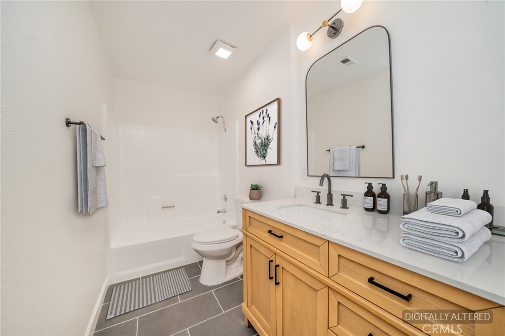 818 Terrace Road San Bernardino, CA 92410 - Photo 29 of 44 a spacious bathroom with a double vanity sink toilet and a mirror