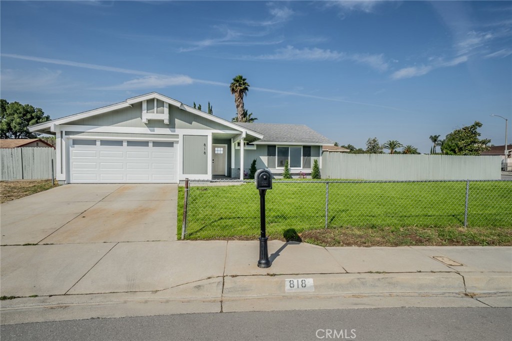 818 Terrace Road San Bernardino, CA 92410 - Photo 3 of 44 a front view of a house with a yard and garage