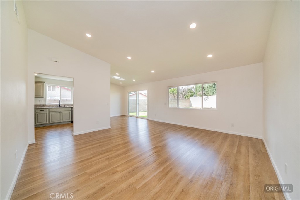 818 Terrace Road San Bernardino, CA 92410 - Photo 8 of 44 a view of an empty room with a window and wooden floor