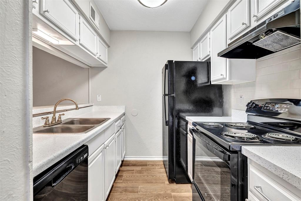 11311 Audelia Road, Unit 271 Dallas, TX 75243 - Photo 3 of 17 Galley kitchen with black appliances