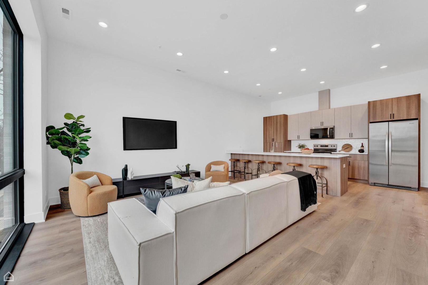 1607 West 13th Street, Unit 200 Chicago, IL 60608 - Photo 17 of 17 a living room with furniture kitchen and a flat screen tv