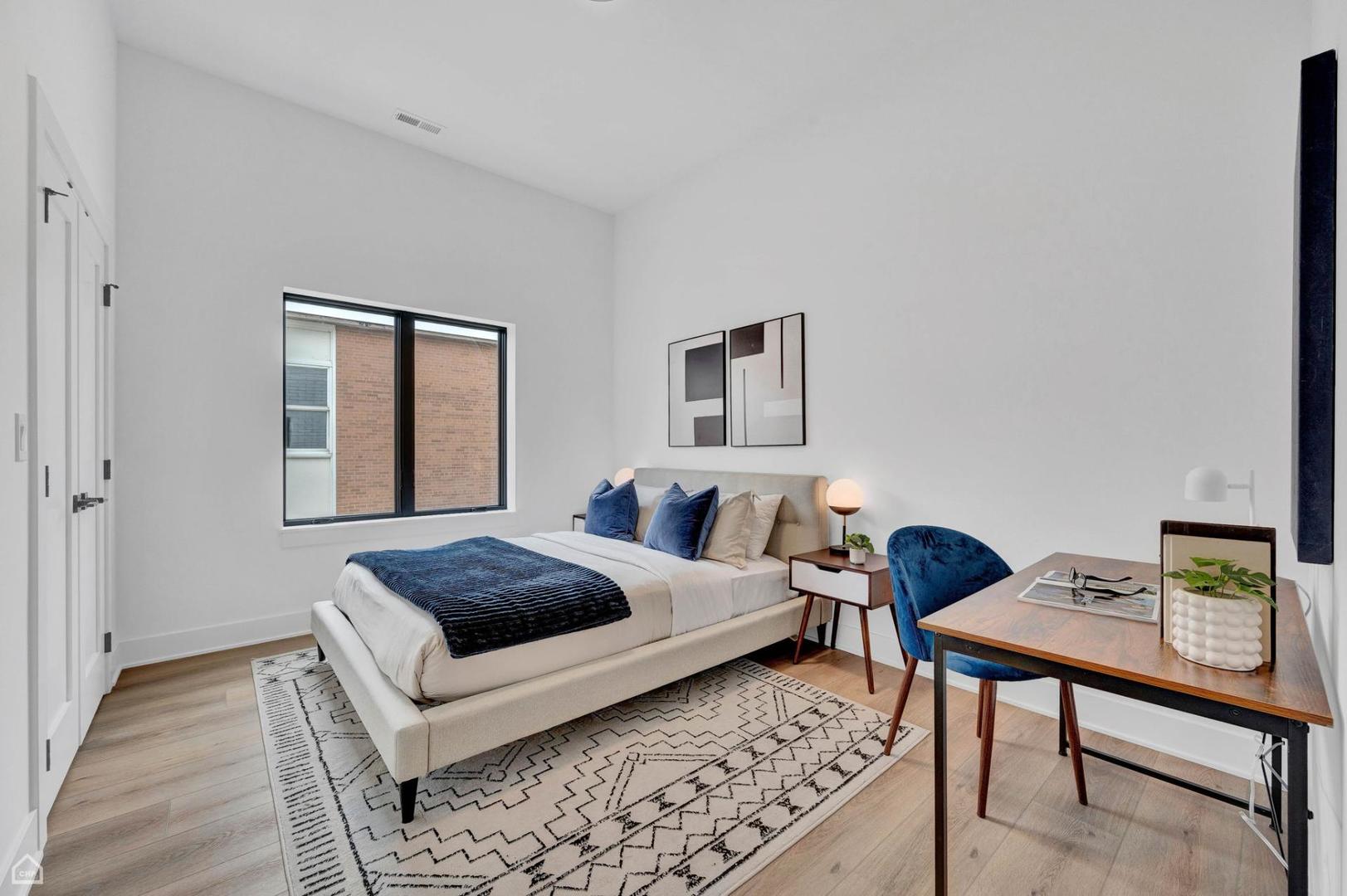 1607 West 13th Street, Unit 200 Chicago, IL 60608 - Photo 9 of 17 a bedroom with a bed and a table in it