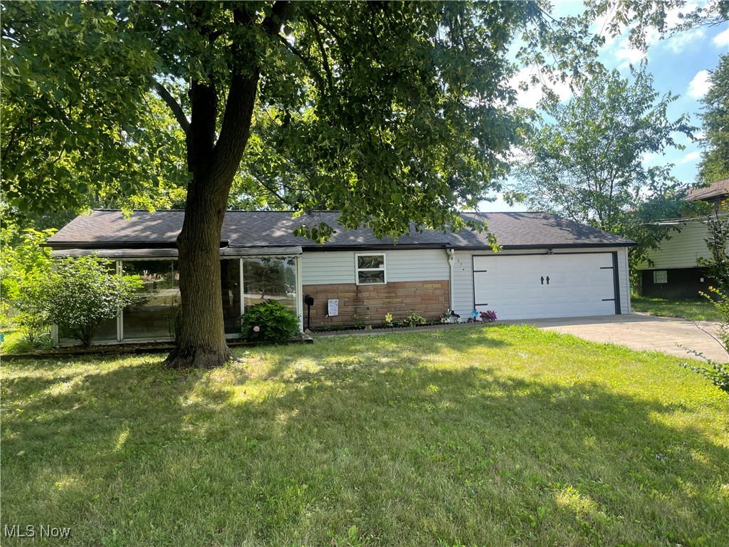 5741 Jaycox Road North Ridgeville, OH 44039 - Photo 2 of 23 Ranch-style home featuring driveway, a front lawn, and a garage