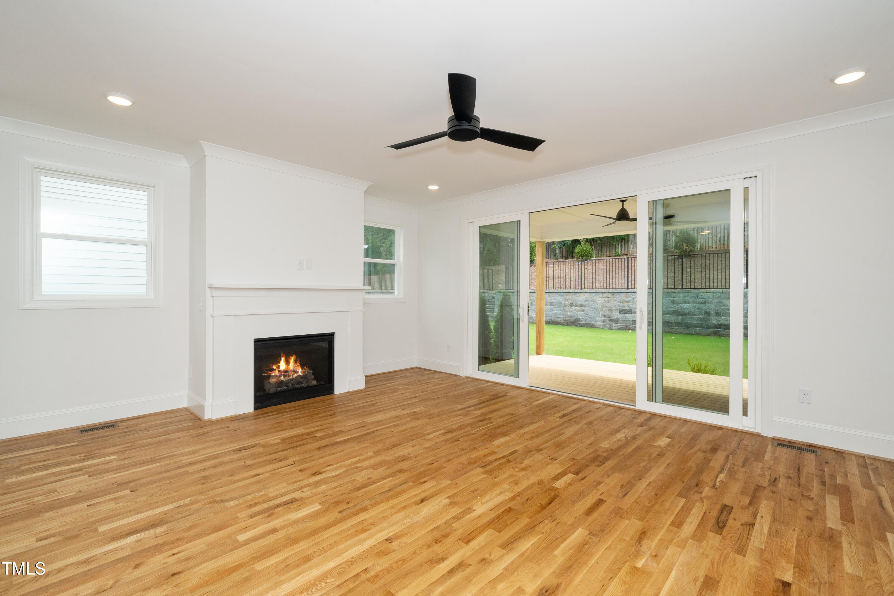 1211 Chaney Road Raleigh, NC 27606 - Photo 13 of 36 a view of an empty room with glass door and a window