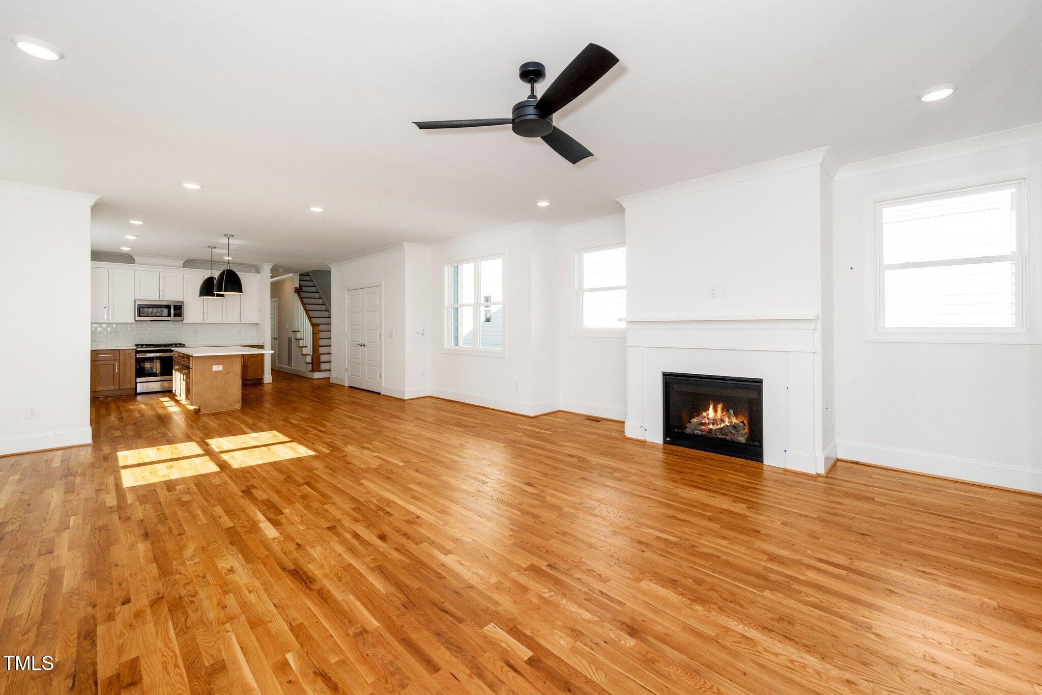 1211 Chaney Road Raleigh, NC 27606 - Photo 15 of 36 a view of empty room with wooden floor and fireplace