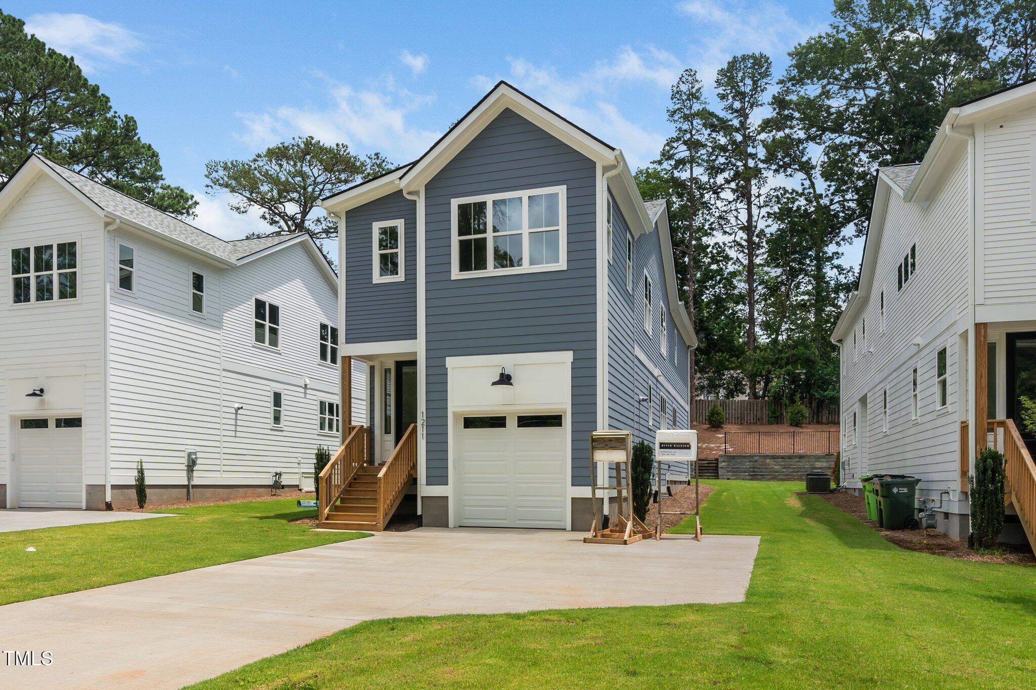 1211 Chaney Road Raleigh, NC 27606 - Photo 2 of 36 a view of a house with a yard and large tree