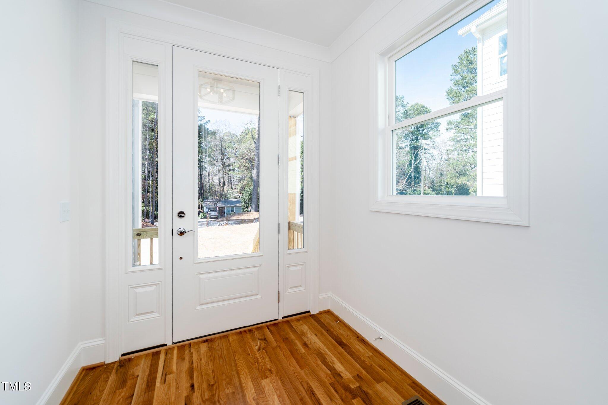 1211 Chaney Road Raleigh, NC 27606 - Photo 5 of 36 a view of empty room with wooden floor and fan