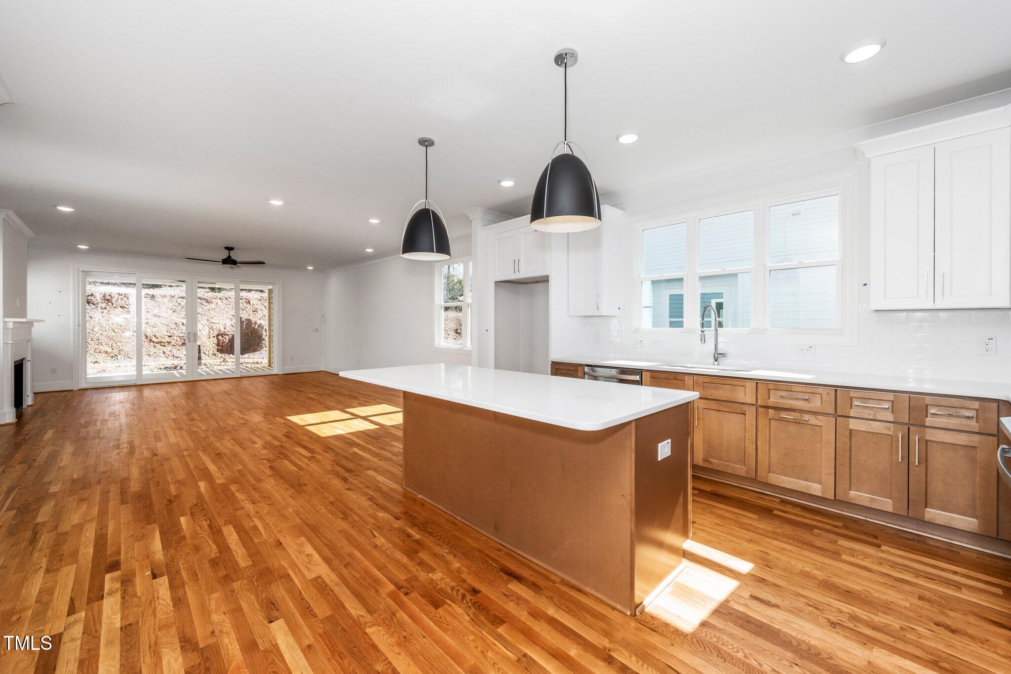 1211 Chaney Road Raleigh, NC 27606 - Photo 7 of 36 a kitchen with stainless steel appliances granite countertop a sink a stove and a wooden floors