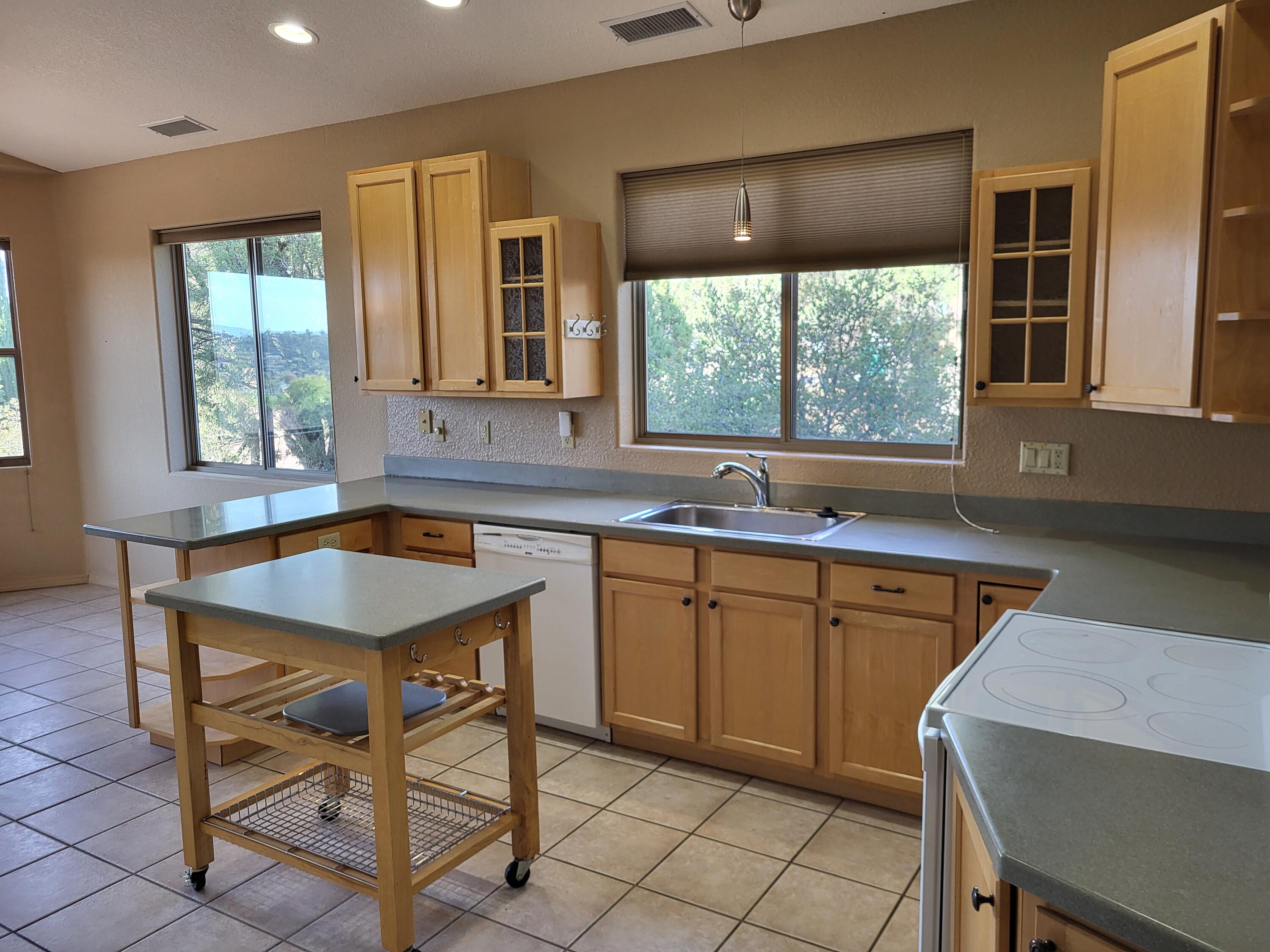 1120 South Sycamore Circle Payson, AZ 85541 - Photo 6 of 44 a kitchen with a sink window and cabinets