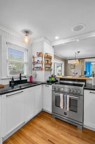 a kitchen with stainless steel appliances granite countertop a stove and a sink