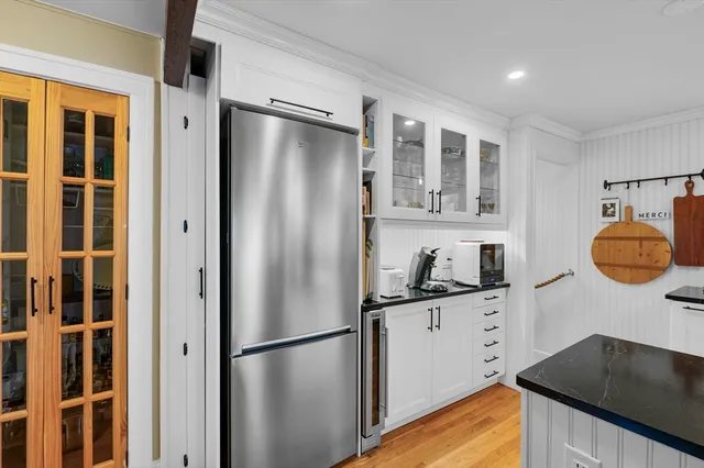 a kitchen with stainless steel appliances granite countertop a refrigerator and a sink