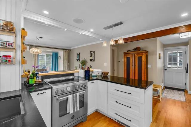 a kitchen with stainless steel appliances granite countertop a stove and a sink