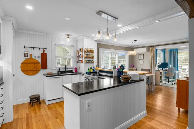 a kitchen with counter top space a sink appliances and cabinets