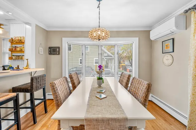 a view of a dining room with furniture window and wooden floor