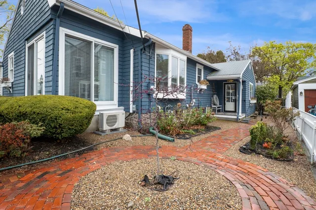 a view of a house with sitting area and garden