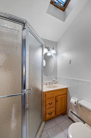 a bathroom with a granite countertop sink mirror vanity and toilet