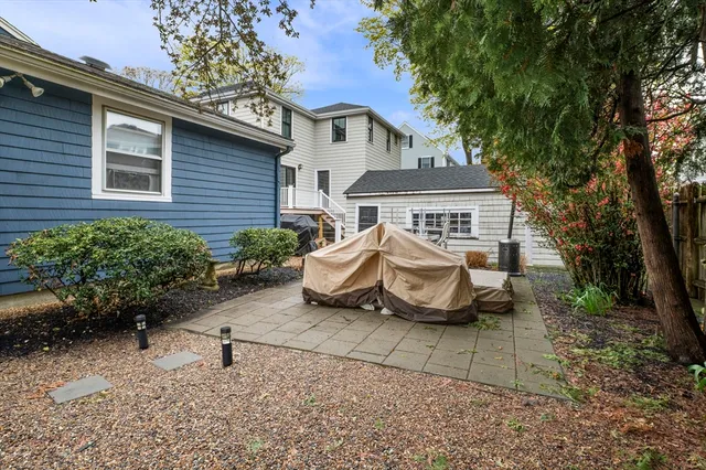 a view of a house with a yard and sitting area