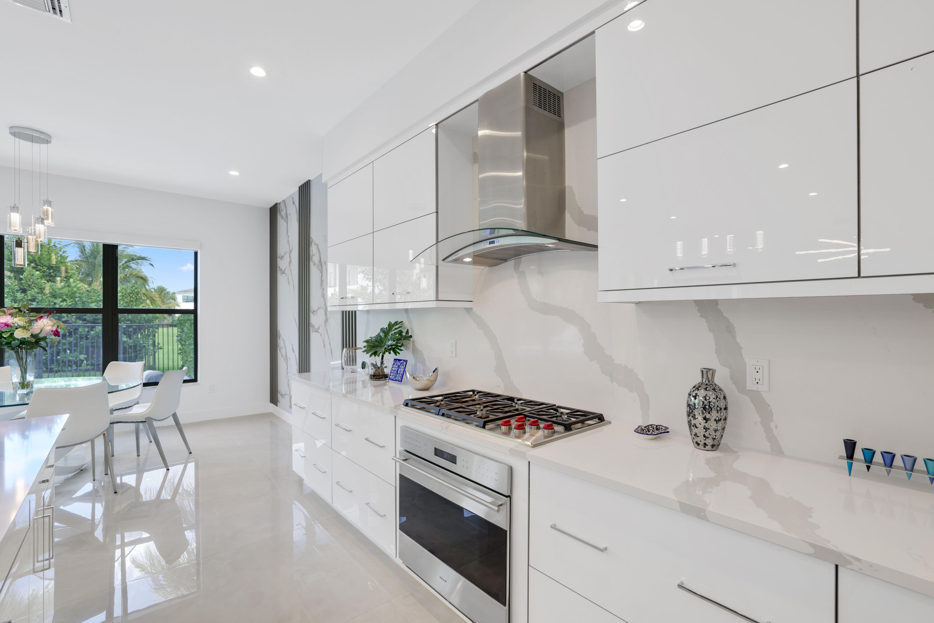 17052 Rainbow Fls Trail Boca Raton, FL 33496 - Photo 28 of 96 a kitchen with stainless steel appliances granite countertop a stove a sink and white cabinets