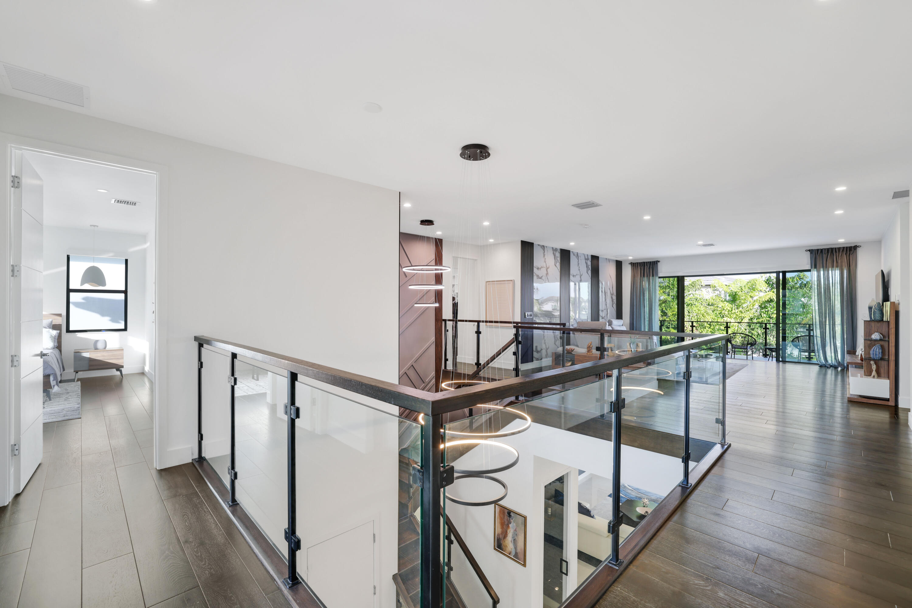 17052 Rainbow Fls Trail Boca Raton, FL 33496 - Photo 68 of 96 a view of a hallway with wooden floor and staircase