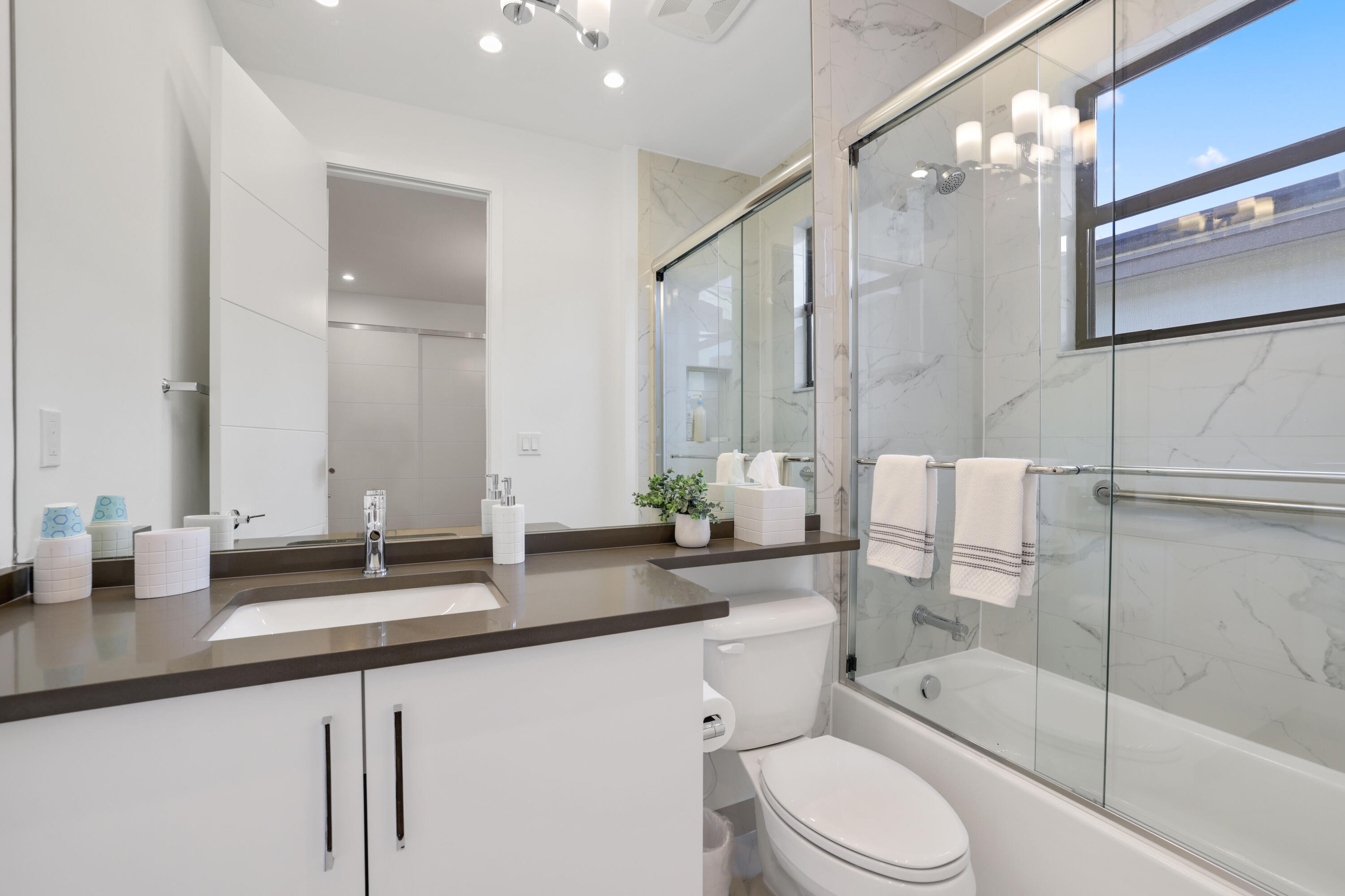 17052 Rainbow Fls Trail Boca Raton, FL 33496 - Photo 71 of 96 a bathroom with a double vanity sink toilet mirror and shower