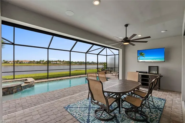 a dining room with furniture and a floor to ceiling window